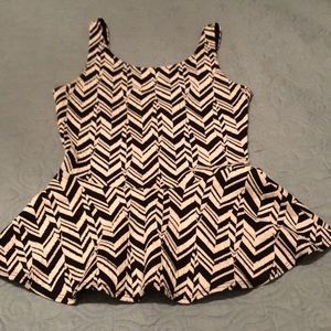 Sleeveless black and white print peplum top